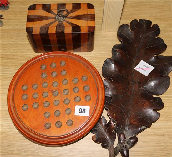 A treen solitaire board and marbles, a parquetry box and treen leaf tray